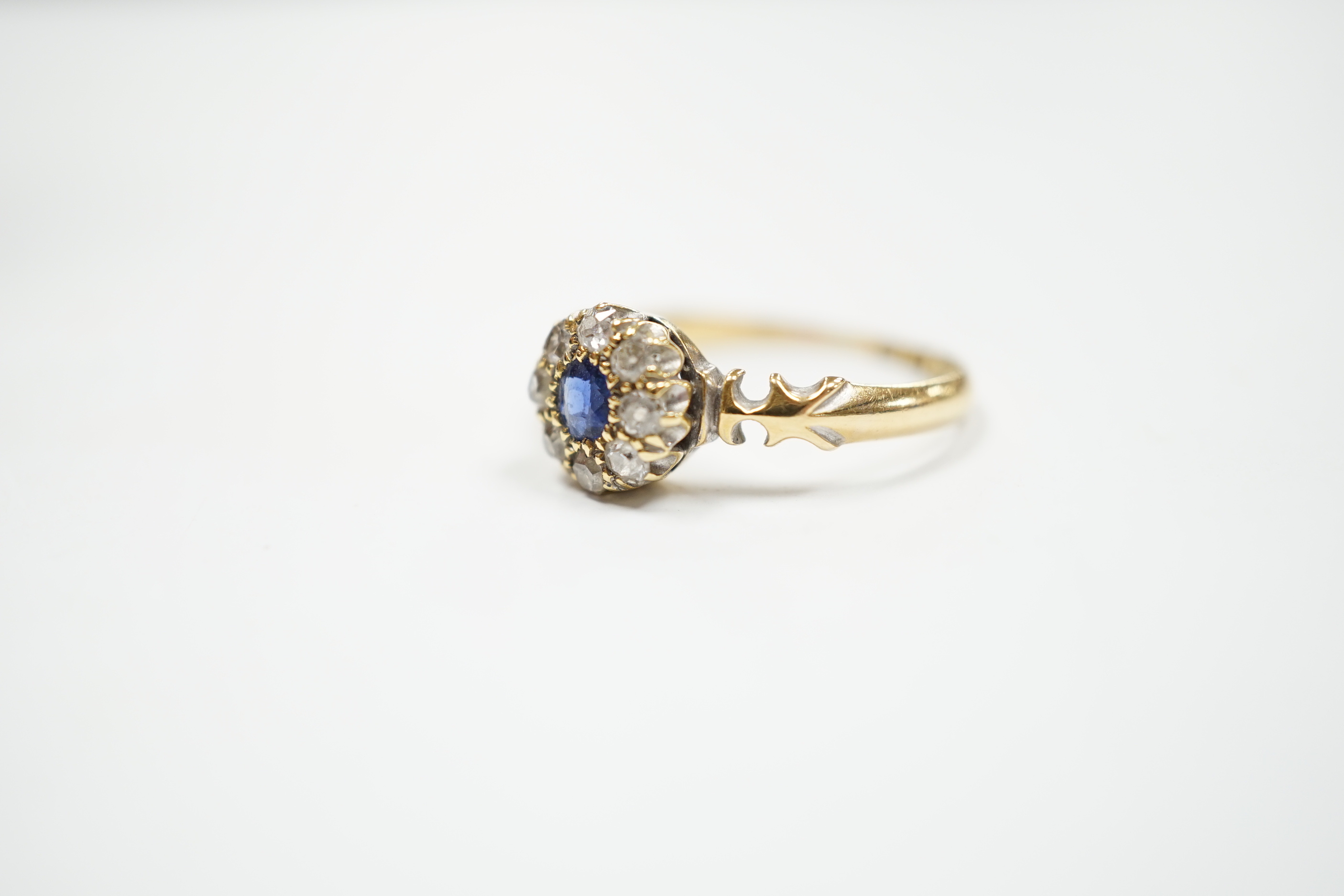 A late Victorian 18ct gold, sapphire and diamond set circular cluster ring, Birmingham, 1889, size M, gross weight 2.7 grams.